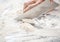 Chef\'s Hand Cutting Dough At Messy Counter