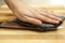 Chef`s hand cutting fish into thin slices with a knife.