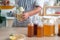 Chef`s hand holds and pouring a bottle and a glass of Homemade fermented kombucha tea