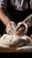 Chef\\\'s hands cracking an egg into a mound of flour, beginning preparation