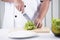 Chef\'s hands cutting lettuce