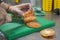 ChefÂ´s hands cutting pink tomato in slices using a sharp knife