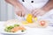 Chef\'s hands cutting yellow bell pepper