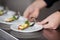 Chef\'s Hands Holding Starters At Kitchen Counter