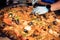 Chef\'s hands preparing a mouthwatering Spanish seafood paella