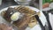 Chef`s hands putting butter on top of the prepared grilled rib dish