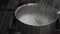 Chef`s hands stirring coconut milk in saucepan