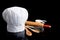 A Chef\'s toque with cooking utensils