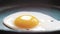 Chef seasons a frying egg, sunny side up, with ground pepper in a small frying pan over an industrial gas burning stove.