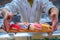 Chef served Japanese Sushi on wooded plate by hand