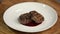 Chef serving meat dish in a plate