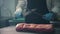 Chef sharpens knife standing in front of raw piece of meat