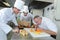 Chef showing students how to chop vegetables with precision