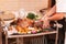 Chef showing turkey dish with vegetables and herbs on a plate in a restaurant for thanksgiving