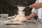 Chef sifting flour on dough in kitchen