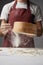 Chef sifting flour with sieve