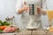 The chef sifts flour into glass bowl for cooking pasta alla carbonara. Backstage of preparing traditional italian dish on white