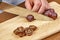 Chef sliced grapes on a cutting board Chef`s hands Close-up