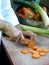 Chef is slicing carrots