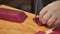 A chef slicing tuna fillet for sashimi producing.