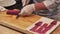 A chef slicing tuna fillet for sashimi producing.