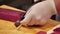 A chef slicing tuna fillet for sashimi producing.