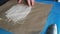 Chef spreading butter on Parchment Paper with a silicone basting brush