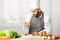 Chef Squeezing Lemon On Fish Steak Plating Dish In Kitchen