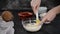 Chef stirring coconut cream in bowl