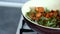 Chef stirring green beans with chicken meat in soy sauce