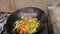 Chef is stirring vegetables in a pan