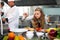 Chef teacher teaches cooking to the group children in class kitchen room