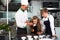 Chef teacher teaches cooking to the group children in class kitchen room.