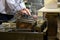 Chef using a metal press to prepare a hamburger patties