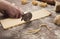 Chef using wheel cutter in preparation of pasta