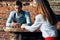 chef waiter takes an order from a young woman in a shirt a cup of coffee cafe restaurant