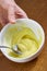 Chef whips yellow cream in a bowl by hand for making cheesecakes complete series of food recipes