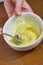 Chef whips yellow cream in a bowl by hand for making cheesecakes complete series of food recipes