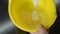 Chef with a whisk whips the pancake dough in a yellow plastic bowl