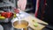 A chef working in the kitchen. Adding the lime juice in the soup