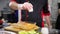 A chef working in the kitchen. Adding sauce in a broth