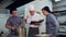 Chef with young cook trainees in the kitchen preparing dish from the cookbook