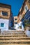 Chefchaouen, Morocco - APRIL 30 2019: View of a narrow street with steps in the blue city on a sunny day