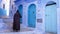 Chefchaouen, Tetouan, Morocco - July 28, 2022: Street scene with a traditionally dressed man.