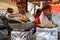 Chefs at a booth make Jalebi Indian spiral fried dough funnel cakes at the Surajkund Crafts