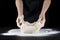 Chefs hands knead the dough. Cooking dough by hand in a bakery