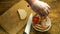 Chefs hands prepares sandwich with smoked chicken breast.