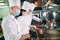 Chefs in protective masks and gloves prepare food in the kitchen of a restaurant or hotel.