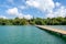 Chek Jawa Broadwalk wooden viewing jetty, view of Chek Jawa Visitor Centre building and mangrove forest on tropical Pulau Ubin