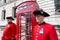 Chelsea pensioners in London standing near a red telephone box.